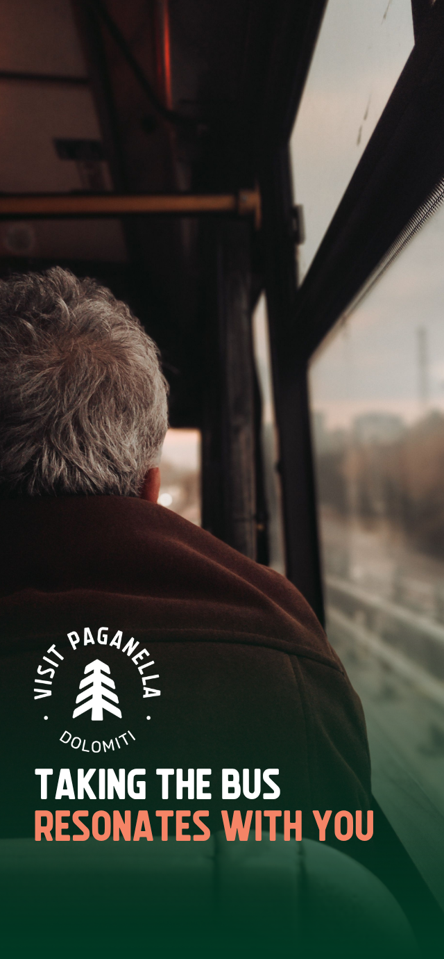 A view from the inside of a bus, looking over the shoulder of a gray-haired passenger who is looking out the window. The atmosphere is characterized by warm lighting and shadows. In the lower left, on a dark green gradient, there is a circular white logo with a stylized pine tree in the center and the words "VISIT PAGANELLA" and "DOLOMITI". Below the logo, the following text is written in uppercase: "TAKING THE BUS" (in white) "RESONATES WITH YOU" (in peach) | © Tuğba Özsoy